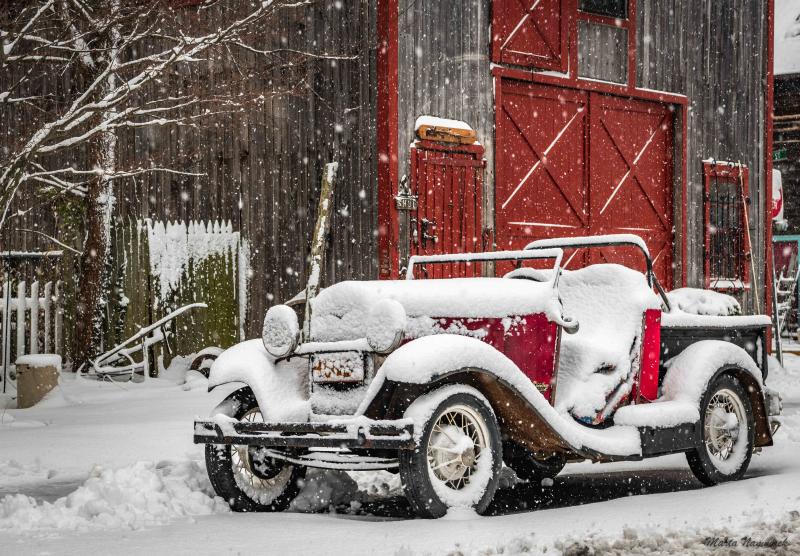 A classic car is blanketed in snow in Marta Nammack’s photo.